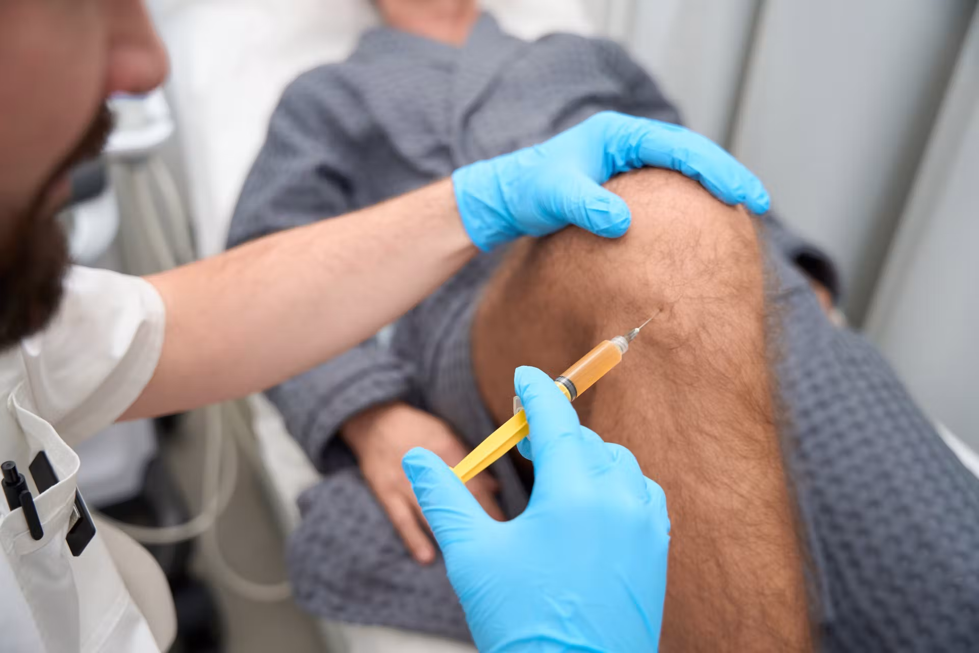 experienced doctor taking a biopsy sample from man 2026 03 10 02 04 08 utc